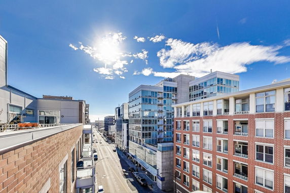 Cityscape view with modern buildings and a sunny sky.