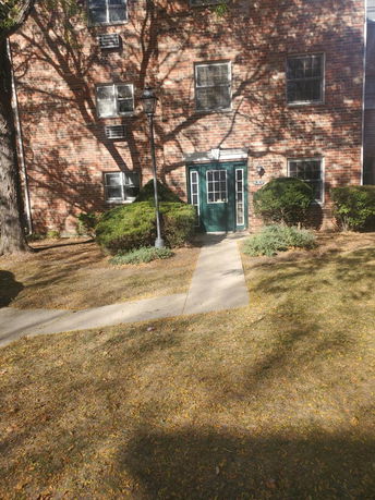 Front view of a brick building with multiple windows and a central entrance.