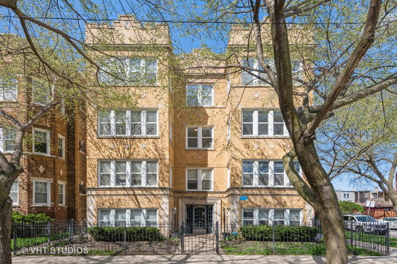 Front view of a multi-story brick apartment building.