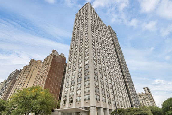 Front view of a tall modern skyscraper with numerous windows.