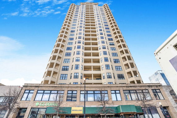 Front view of a high-rise building with multiple balconies.