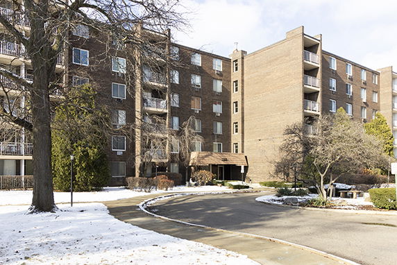Front view of a multi-story brick apartment building.