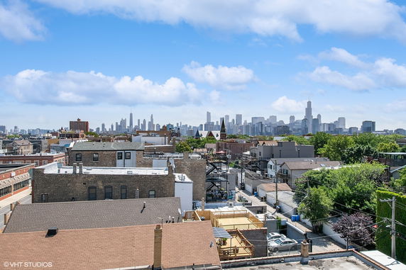 Panoramic view of city skyline with various buildings in the foreground.