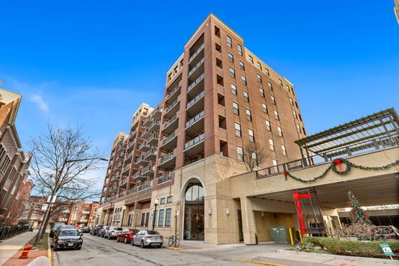 Front view of a multi-story residential building with balconies.