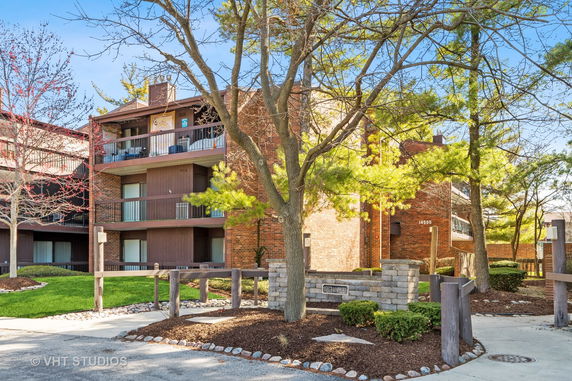 Front view of a multi-story apartment building with balconies.