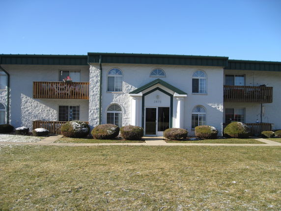 Front view of a two-story apartment building with balconies
