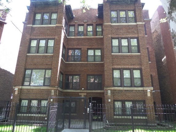 Front view of a multi-story brick apartment building.