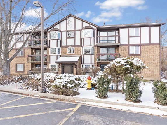 Front view of a multi-story building with snow-covered surroundings.
