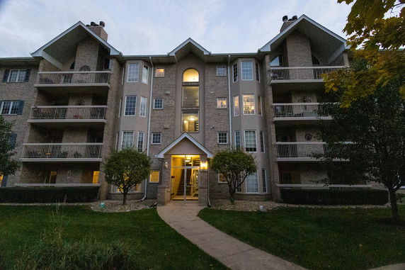 Front view of a multi-story residential building with balconies.