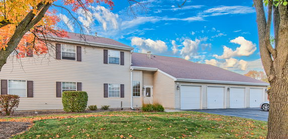 Front view of a two-story house with a three-car garage.