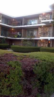 Front view of a multi-story building with balconies.