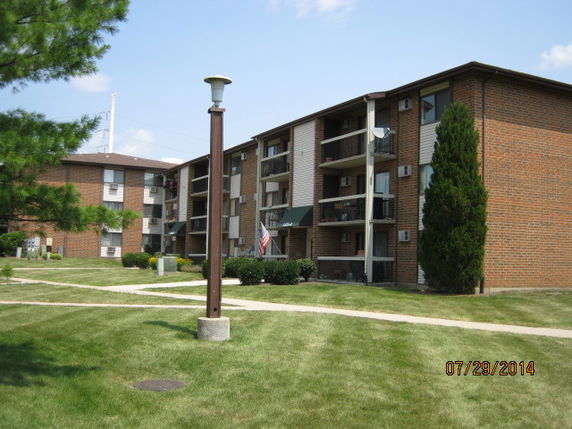 Front view of a multi-story brick apartment building.