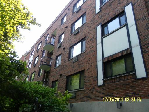 Front view of a multi-story brick apartment building.