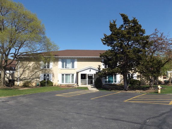 Front view of a two-story building with a central entrance.