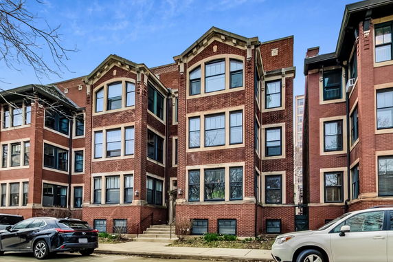 Front view of a three-story brick apartment building.