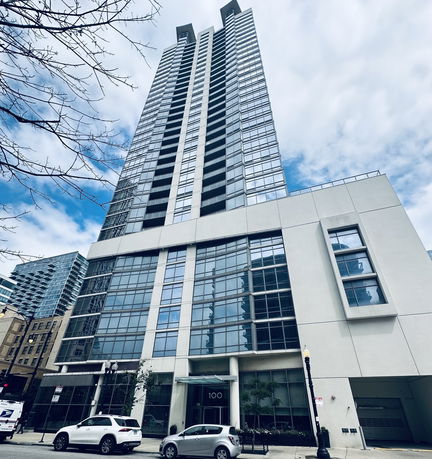 Front view of a high-rise residential building with large windows.