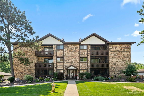 Front view of a multi-story brick building with balconies.
