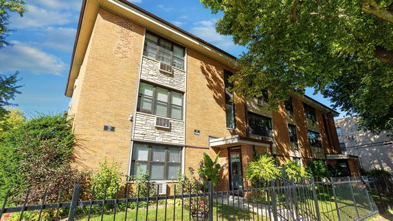 Front view of a three-story brick apartment building.