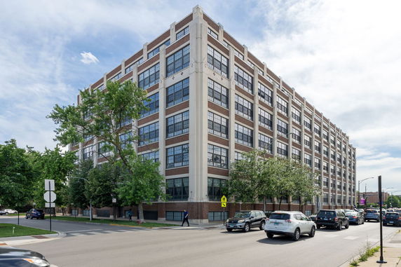 Front view of a multi-story commercial building with large windows.