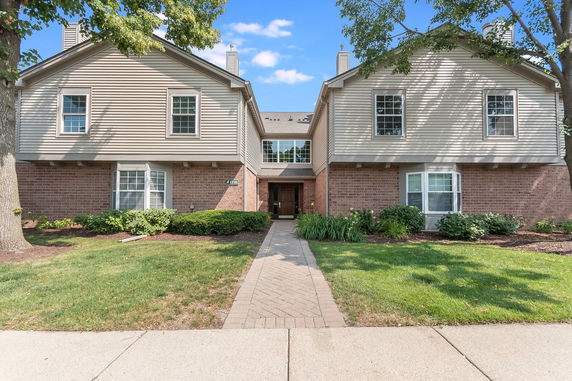 Front view of a two-story house with brick and siding exterior.