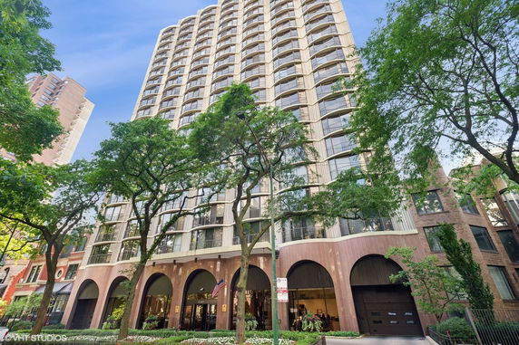 Front view of a tall apartment building with a curved facade.
