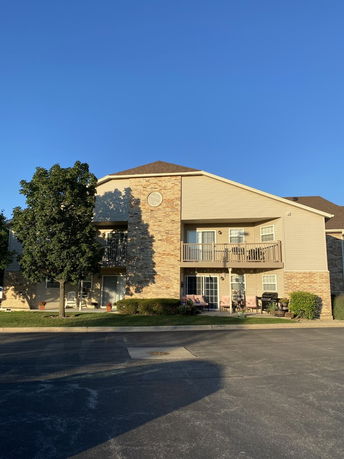 Front view of a two-story residential building with balconies.