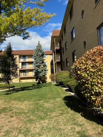 View of surrounding areas of a multi-story residential building with balconies.