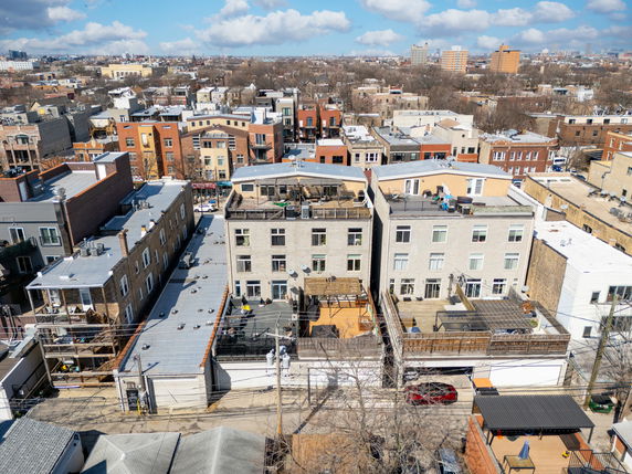 Panoramic view of urban residential buildings with rooftop decks.