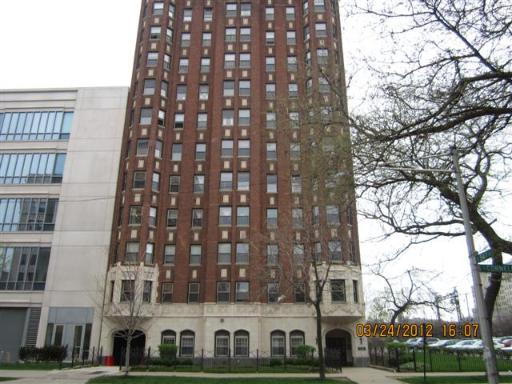 Front view of a tall brick residential building.