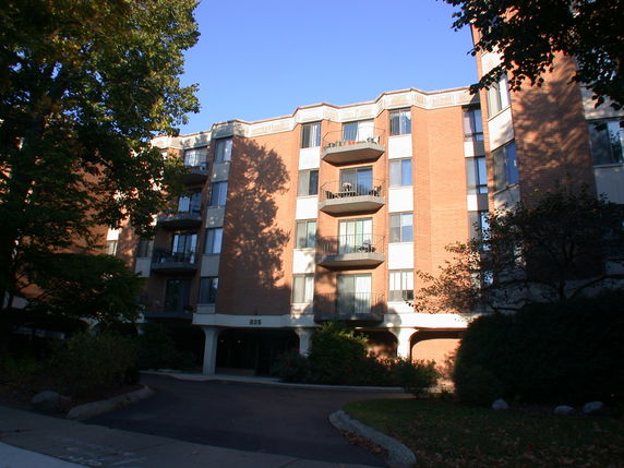 Front view of a multi-story apartment building with balconies.
