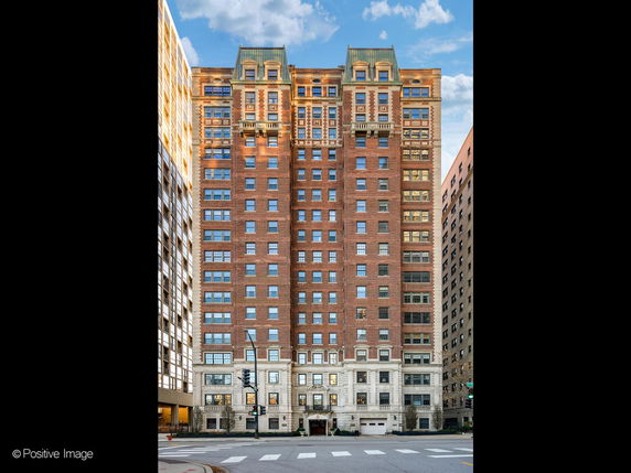 Front view of a multi-story brick building with decorative architecture.
