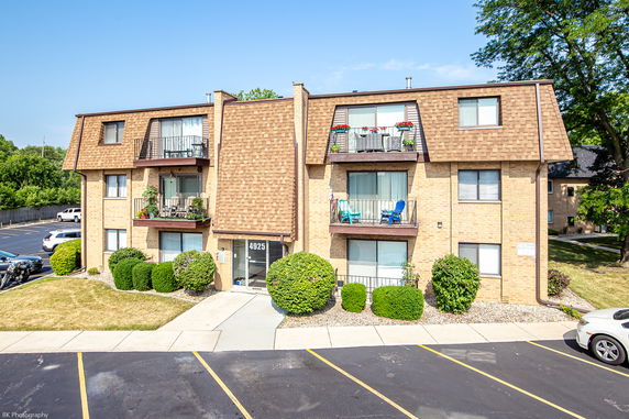 Front view of a multi-story apartment building with balconies.