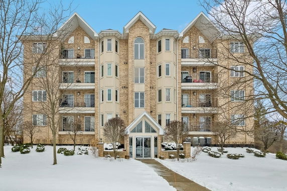 Front view of a multi-story apartment building with balconies.