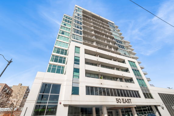 Front view of a multi-story building with large windows and balconies.