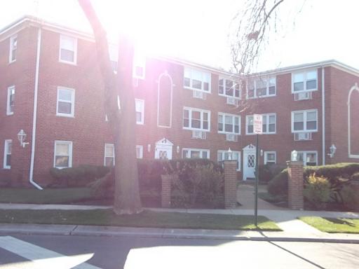 Front view of a three-story brick apartment building.