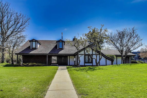 Front view of a house with a sloped roof and dormer windows.