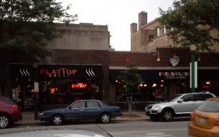 Front view of a row of commercial buildings with storefronts.