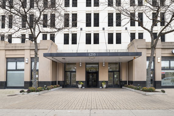 Front view of a multi-story building with an entrance canopy.