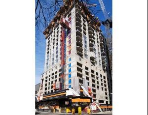 Front view of a high-rise building under construction.