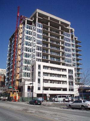 Front view of a multi-story building under construction.