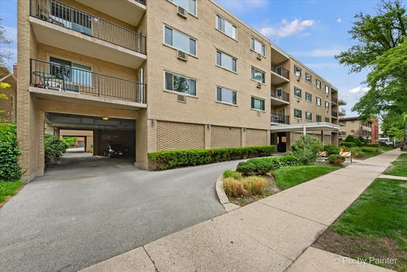 Front view of a multi-story apartment building with balconies.