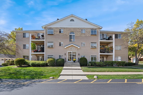 Front view of a multi-story residential building with balconies.