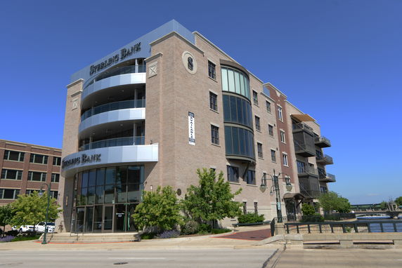 Front view of a multi-story commercial building with brick exterior and prominent signage.