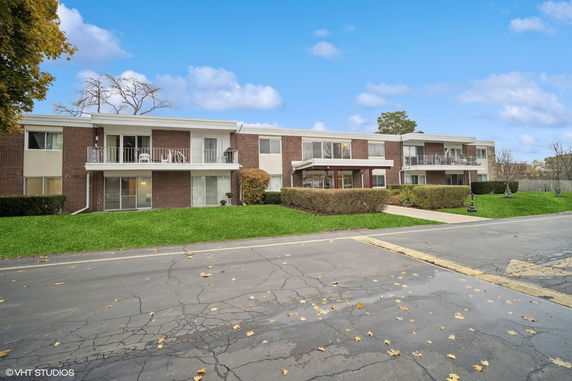 Front view of a two-story residential building with balconies.
