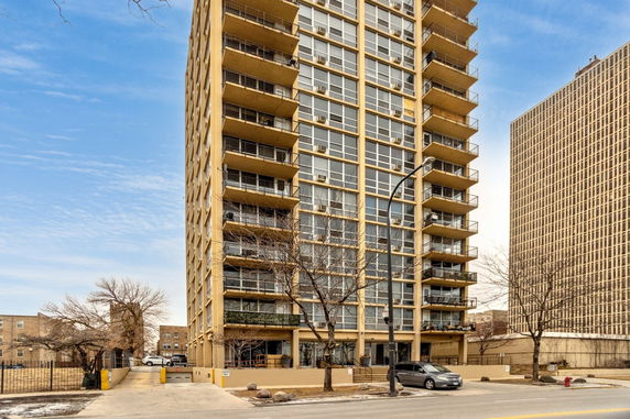 Front view of a multi-story residential building with balconies.