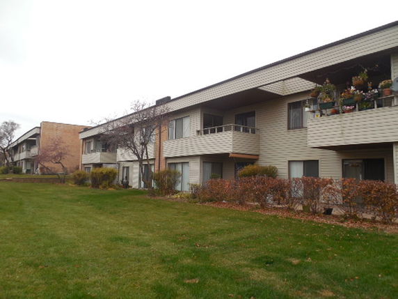 Front view of a two-story apartment building with balconies.