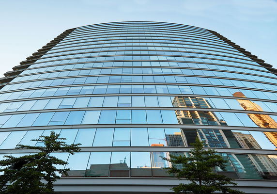 Front view of a modern, multi-story building with a glass facade.