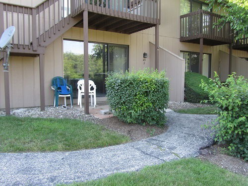 Front view of a multi-story residential building with staircases and balconies.