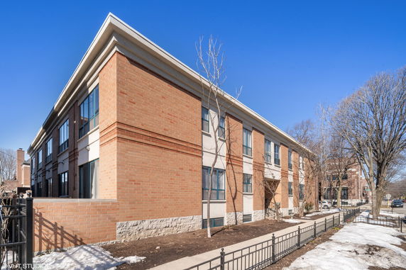 Front view of a two-story brick building with multiple windows.