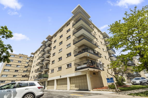 Front view of a multi-story apartment building with balconies.